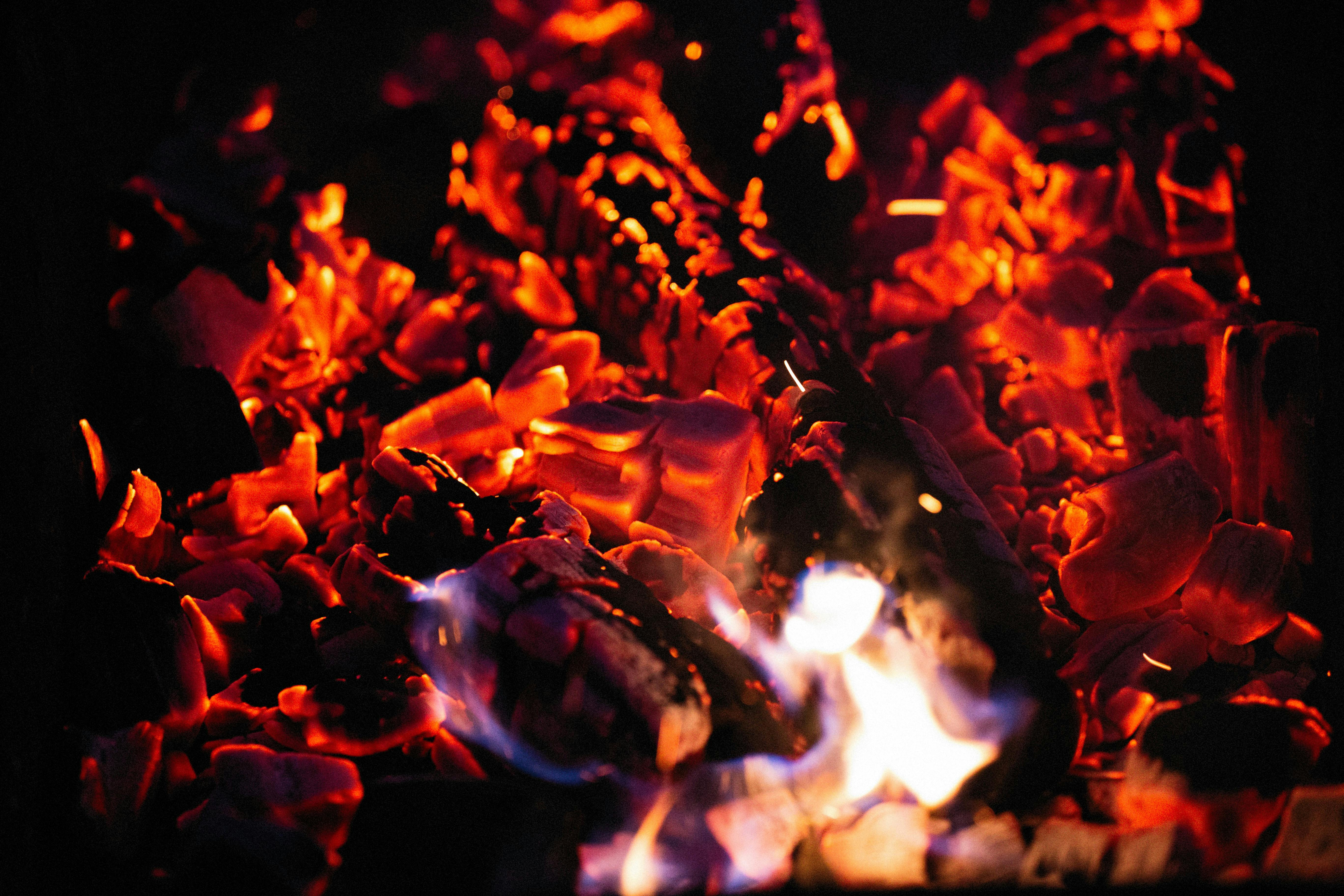 Glowing coal embers at night.